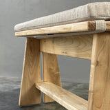 Wooden chair with a gray cushion on a gray background