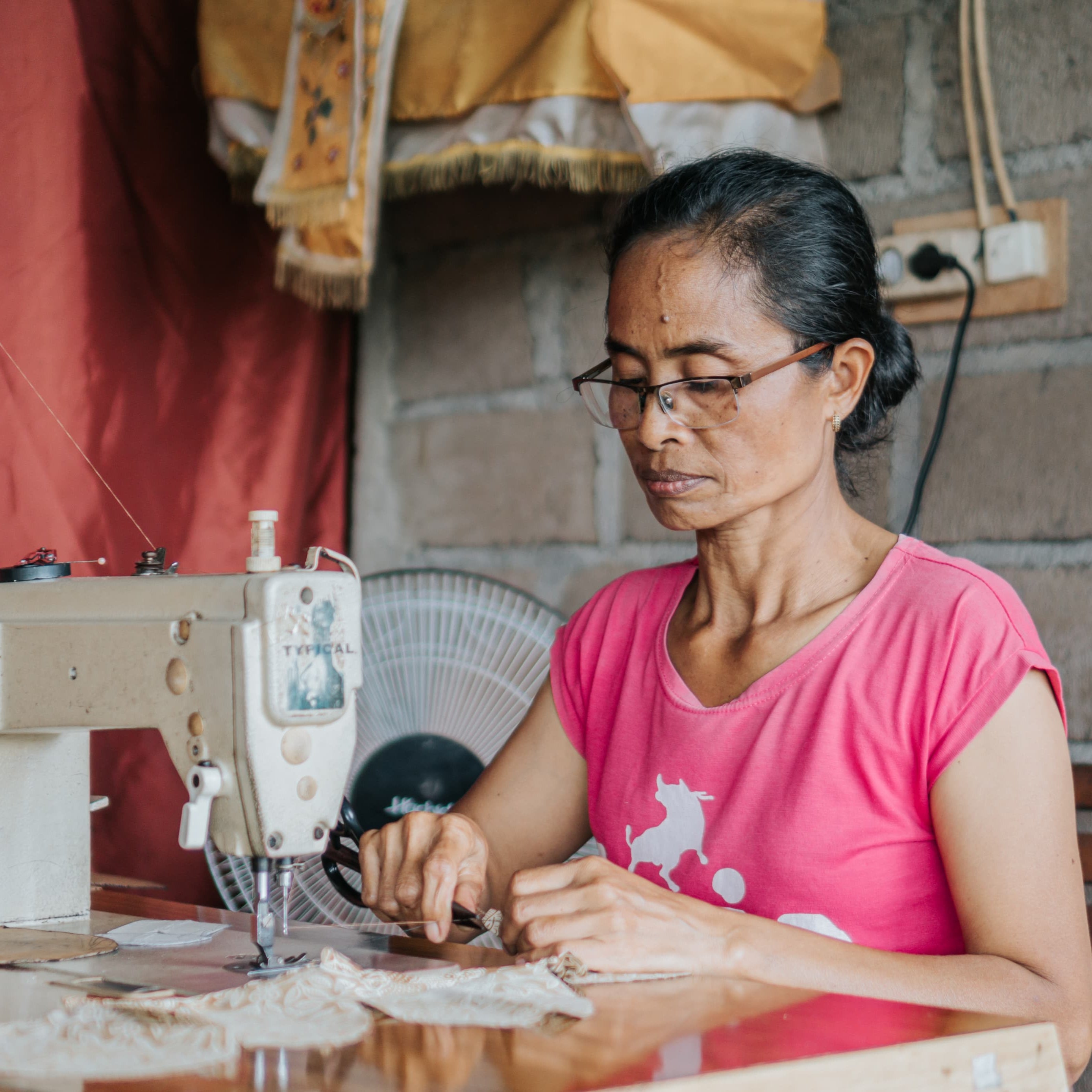 Woman working on a sewing machine in a home setting