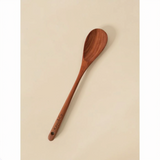 Wooden spoon with 'Kate & Co' engraving on a beige background