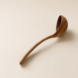 Wooden ladle on a beige background