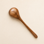 Wooden spoon on a beige background
