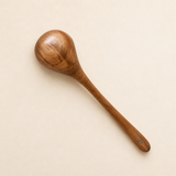 Wooden spoon on a beige background