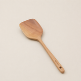 Wooden spatula on a beige background